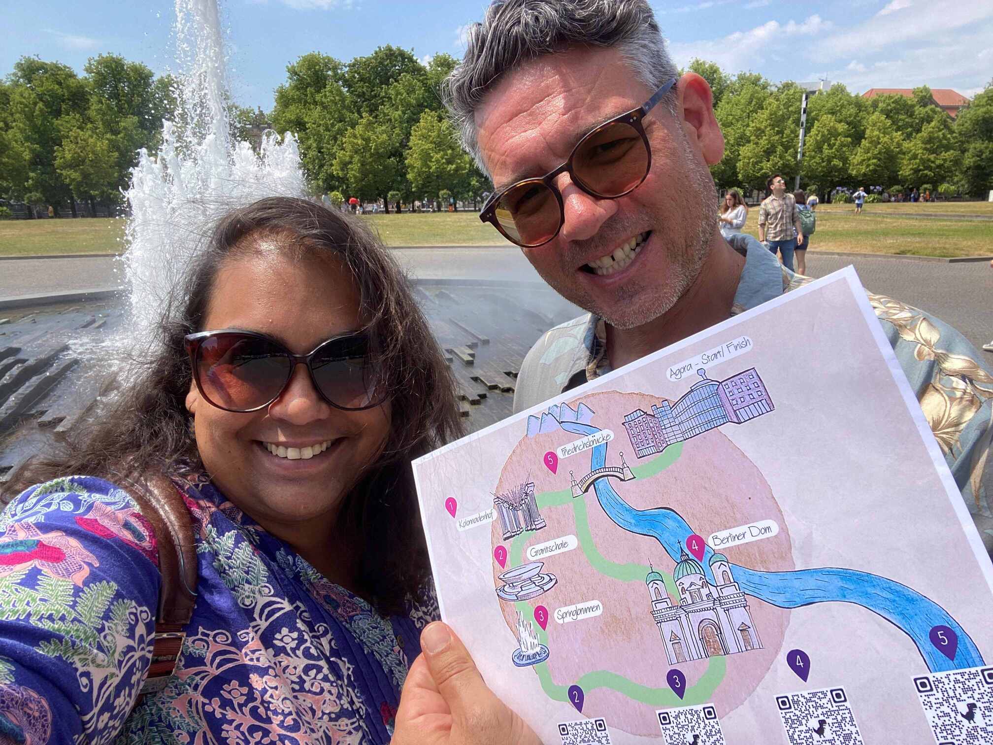 Photo shows 2 ExL Designers holding up an Interactive map as part of a corporate experience day in Berlin, Germany.